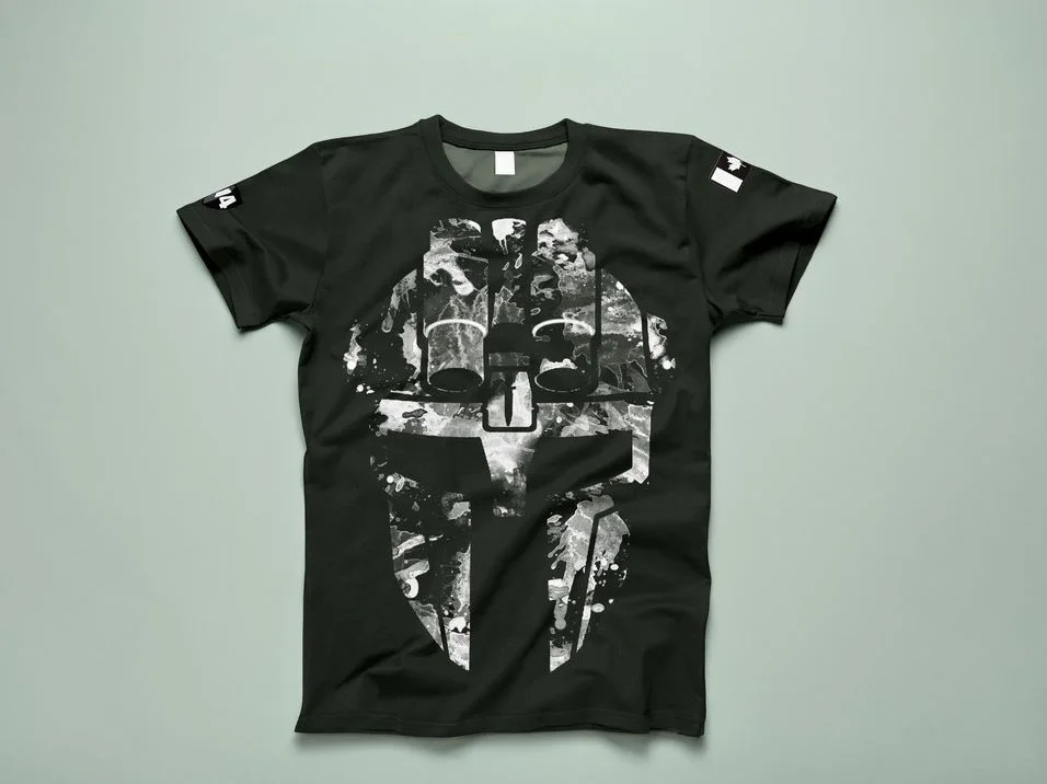 Black t-shirt printed with a large splatter-textured mask, with small prints on both sleeves
