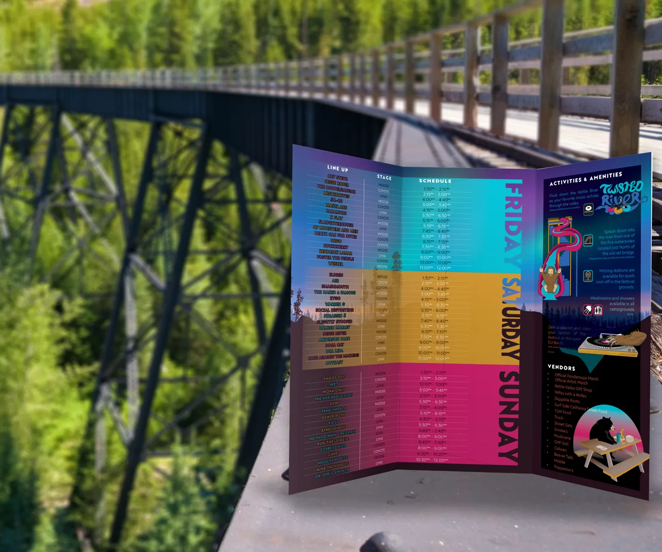 Festival brochure opened out on a railing, with the Kettle Valley trestle bridge and forest behind it