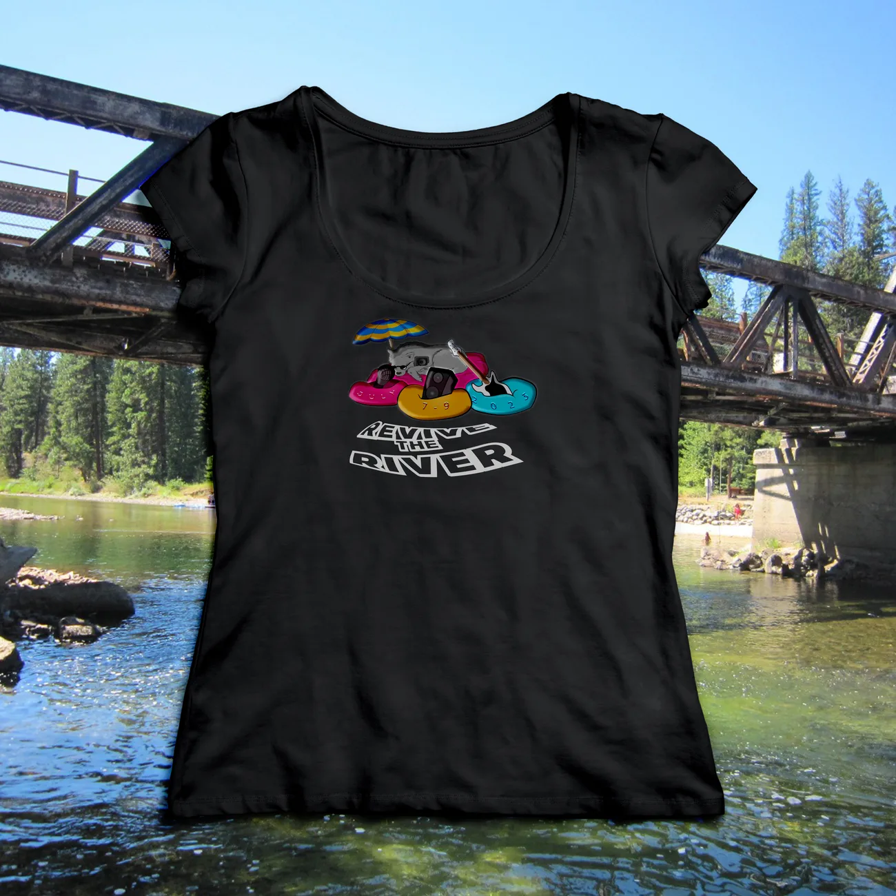 Black t-shirt photographed by a river, printed with a bear floating on an inner tube