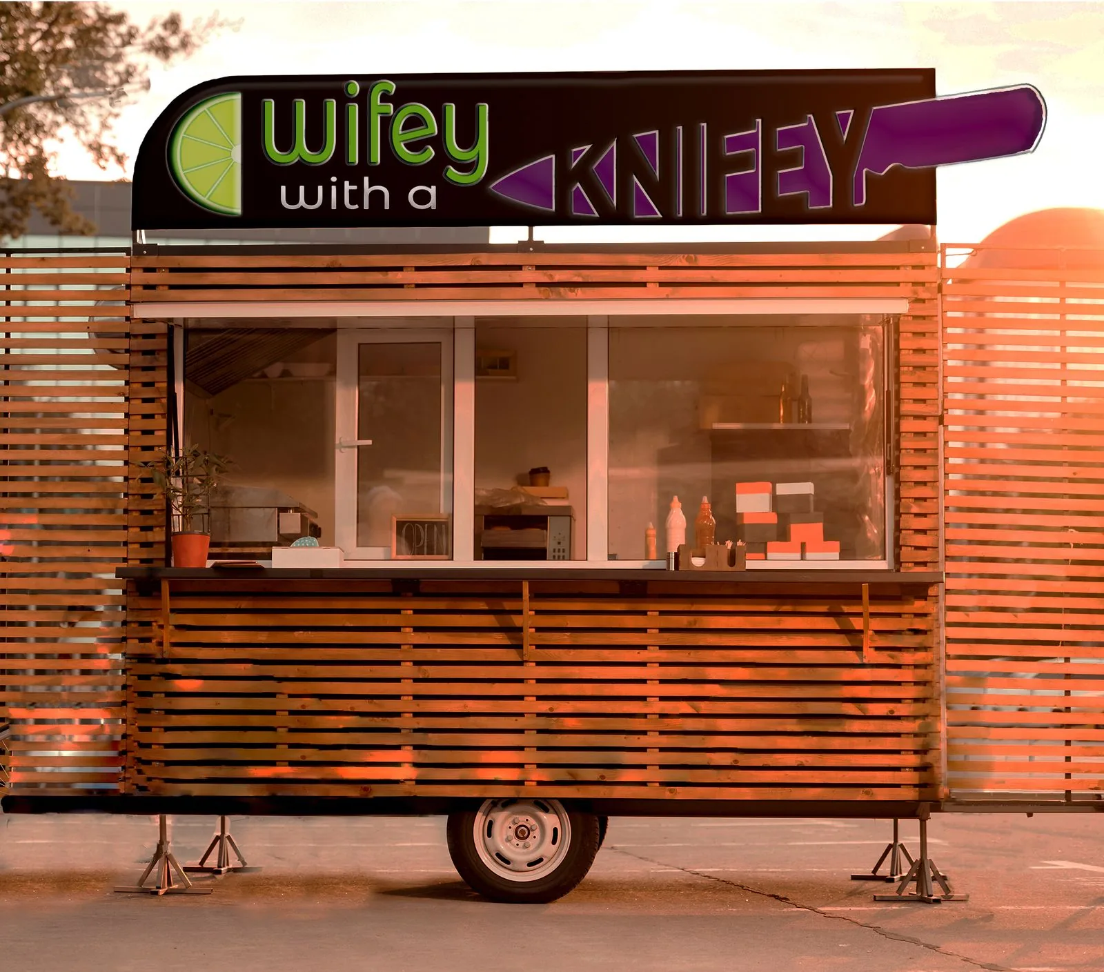 The mark on the illuminated header board of a timber-clad food cart, photographed at sunset with the serving window open