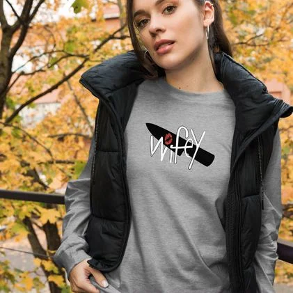 Woman in a heather grey long-sleeve tee printed with the Wifey submark, under a black puffer vest